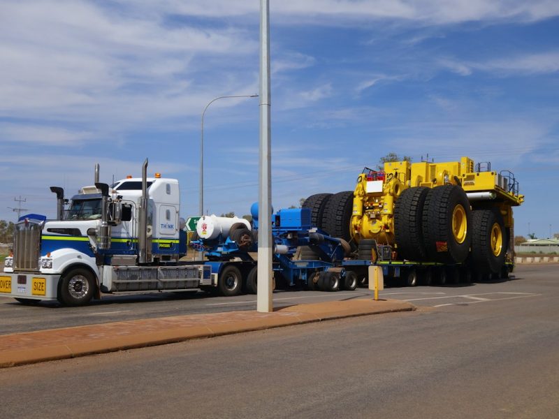 Heavy vehicle carried on a lowboy trailer