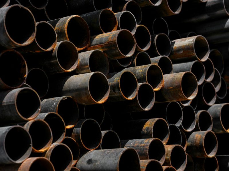 Stacked steel pipes in a yard